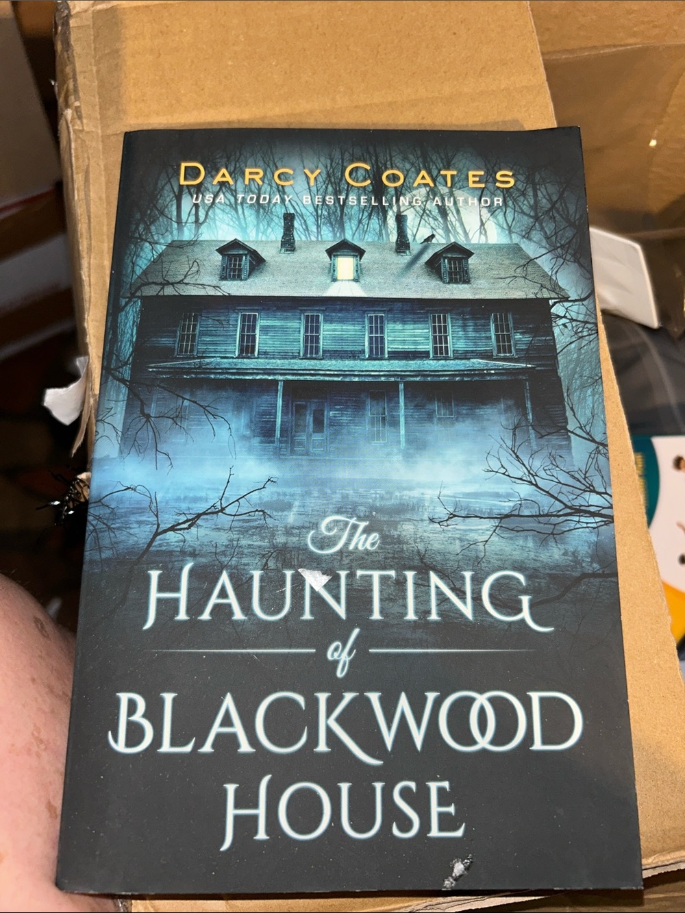 The Haunting of Blackwood House by Darcy Coates - Teal & Black Paperback